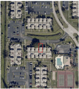 Aerial view showing the surrounding neighborhood and the townhouse unit highlighted in red.